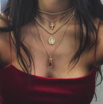 Multi-Layer Necklace with Cross and Virgin Mary Design